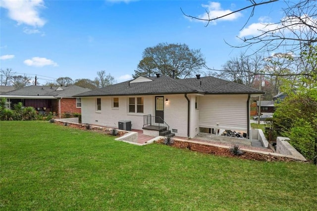 back of house featuring a yard and central air condition unit