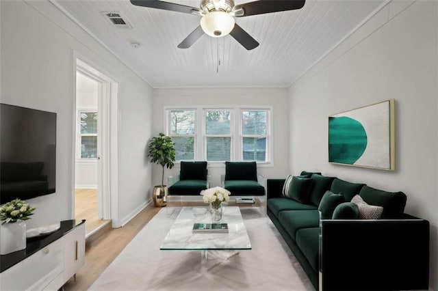 living room featuring ceiling fan, light hardwood / wood-style flooring, and crown molding