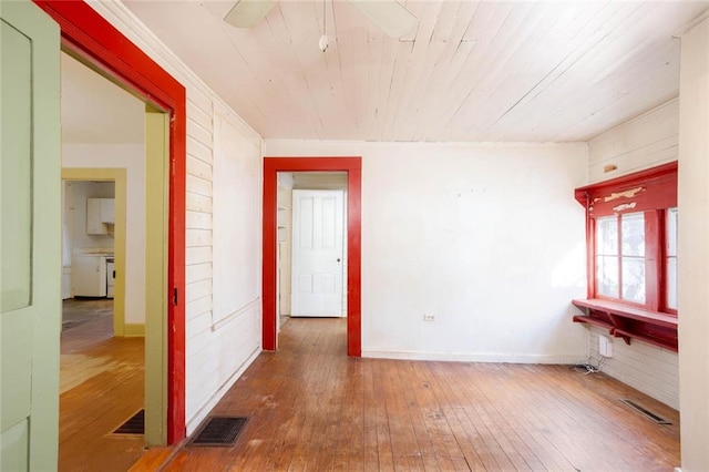 unfurnished room featuring wood ceiling and hardwood / wood-style flooring