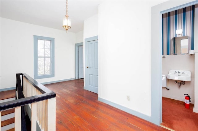 hallway with dark hardwood / wood-style floors and sink