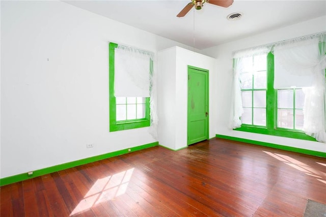 unfurnished room with ceiling fan and dark hardwood / wood-style flooring