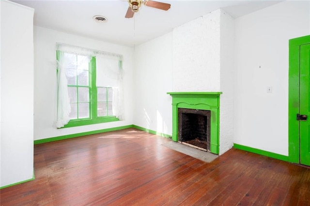 unfurnished living room with ceiling fan and dark hardwood / wood-style floors