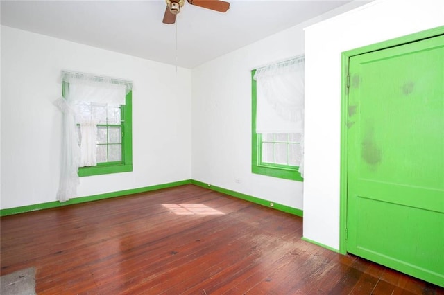 unfurnished room featuring ceiling fan and dark hardwood / wood-style flooring