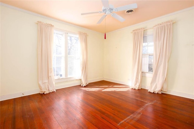 unfurnished room with ornamental molding, plenty of natural light, ceiling fan, and dark hardwood / wood-style flooring