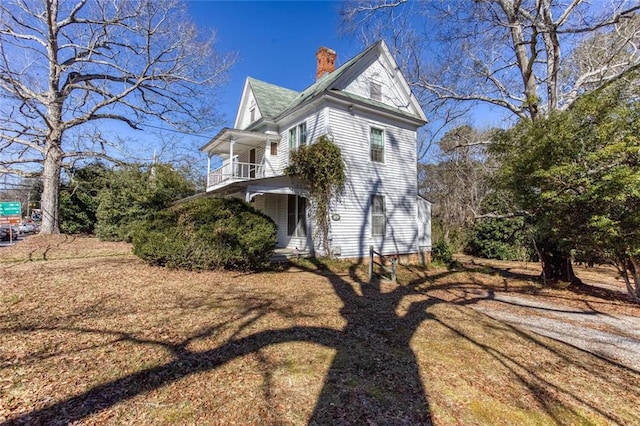 view of side of home featuring a balcony