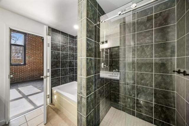 full bath featuring tiled shower, tile patterned flooring, and a bath