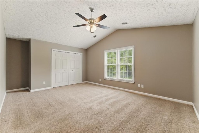 2154 Marne Gln NW, Kennesaw, GA 30152 - unfurnished bedroom featuring baseboards, a closet, carpet floors, vaulted ceiling, and a textured ceiling