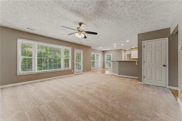 2154 Marne Gln NW, Kennesaw, GA 30152 - unfurnished living room featuring light carpet, ceiling fan, a textured ceiling, baseboards, and recessed lighting