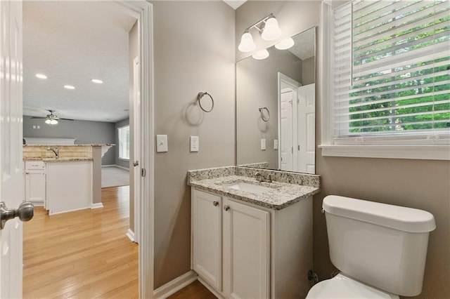 2154 Marne Gln NW, Kennesaw, GA 30152 - half bath featuring wood finished floors, vanity, toilet, ceiling fan, and baseboards