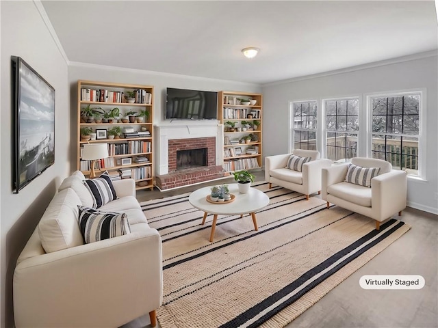 living room featuring crown molding, wood-type flooring, a brick fireplace, and a wealth of natural light