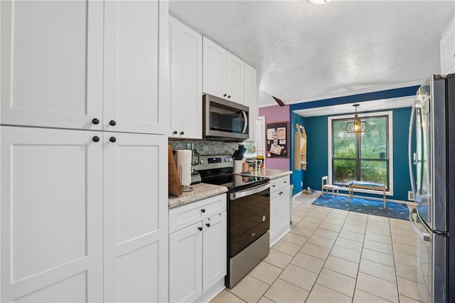 5360 Fieldgreen Dr, Stone Mountain, GA 30088 - kitchen featuring stainless steel appliances, light tile patterned floors, a textured ceiling, white cabinets, and tasteful backsplash