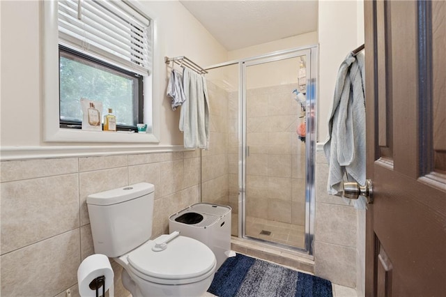 5360 Fieldgreen Dr, Stone Mountain, GA 30088 - bathroom with tile walls, a shower stall, and a wainscoted wall