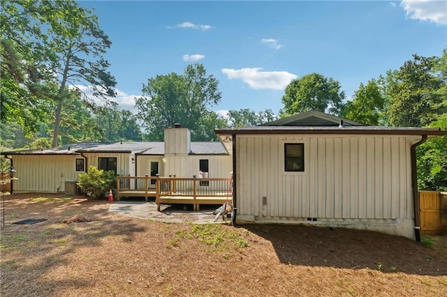 5360 Fieldgreen Dr, Stone Mountain, GA 30088 - rear view of property with a deck, a chimney, and board and batten siding
