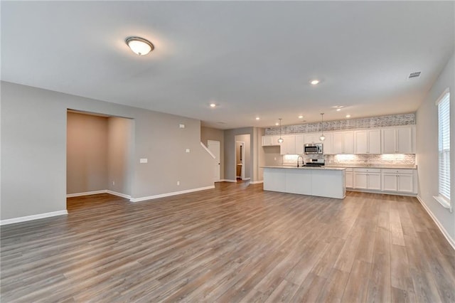 unfurnished living room with light hardwood / wood-style floors