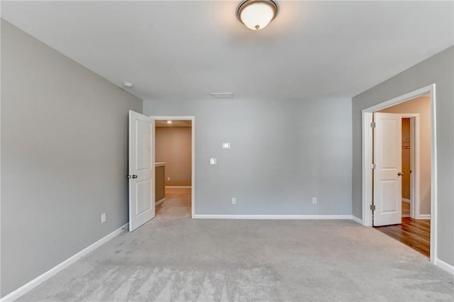 unfurnished room with light carpet