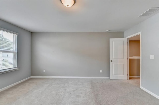 empty room featuring light carpet