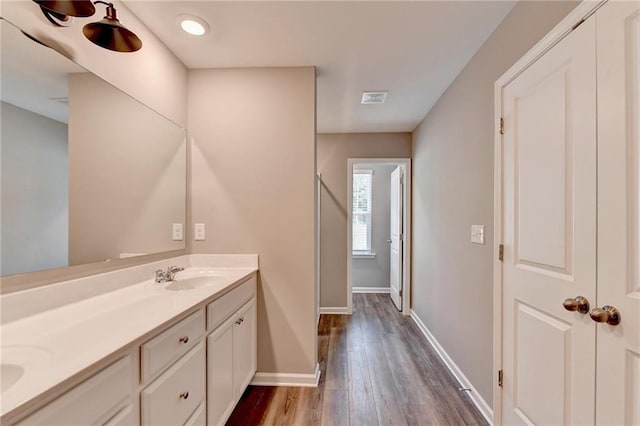 bathroom featuring vanity and hardwood / wood-style flooring