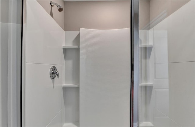 bathroom featuring a shower with door