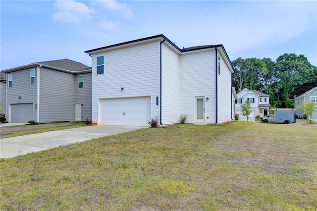 rear view of property with a lawn and a garage