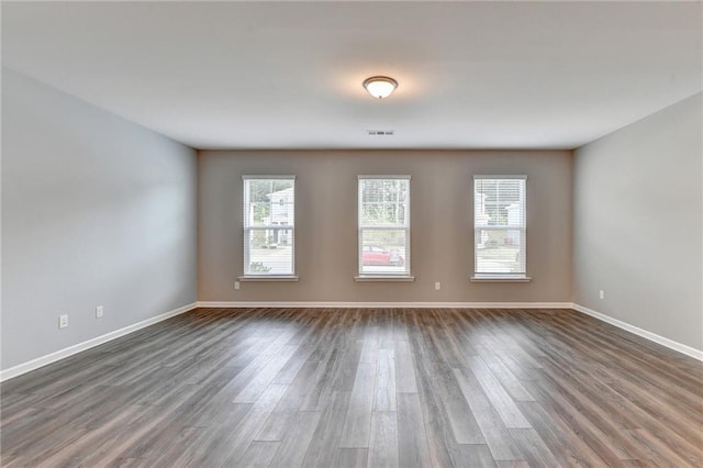 empty room featuring dark hardwood / wood-style flooring