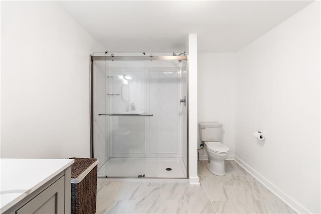 bathroom with vanity, a shower with shower door, and toilet