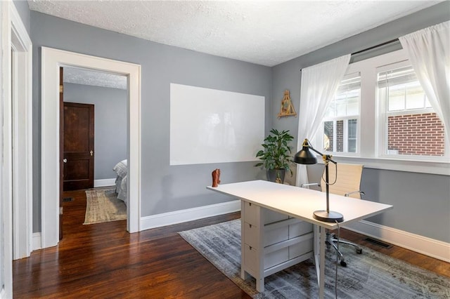 office space featuring dark hardwood / wood-style flooring and a textured ceiling