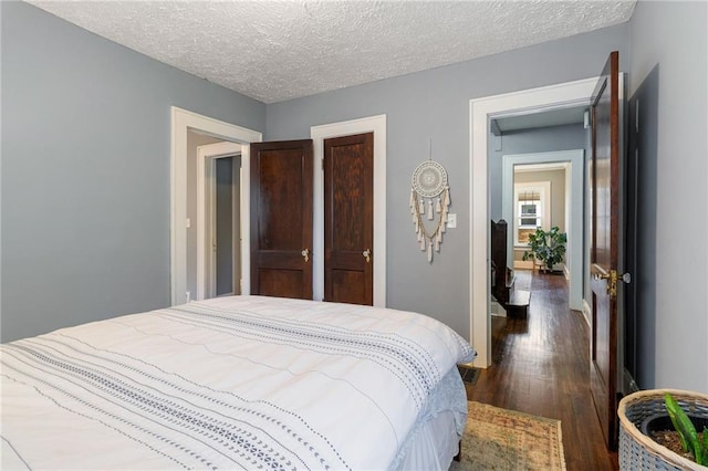 bedroom featuring dark hardwood / wood-style floors and a textured ceiling