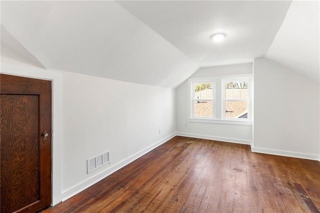 additional living space with lofted ceiling and dark wood-type flooring