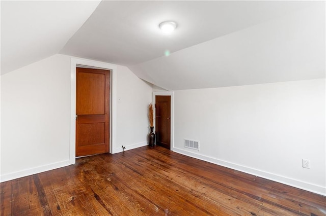 bonus room featuring dark wood-type flooring and vaulted ceiling