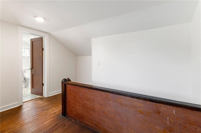 additional living space featuring dark hardwood / wood-style flooring and vaulted ceiling