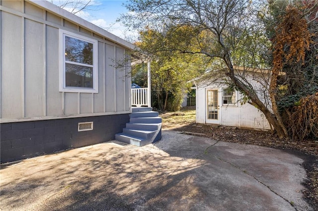 view of side of home featuring a patio area