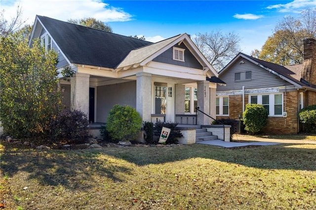 craftsman-style house with a front lawn and a porch