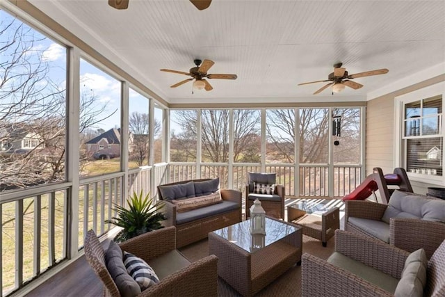 sunroom featuring a ceiling fan