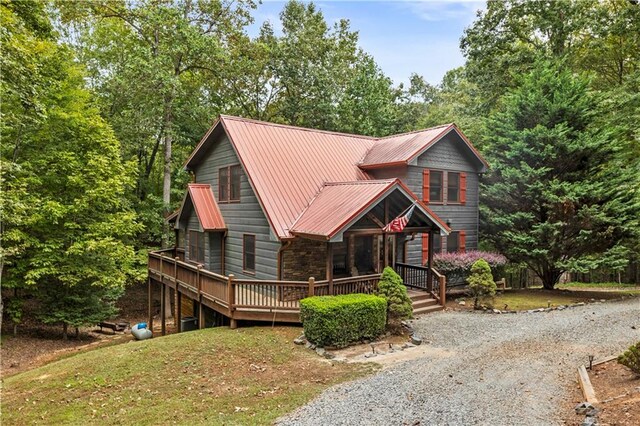 view of front of home with a front lawn and a deck