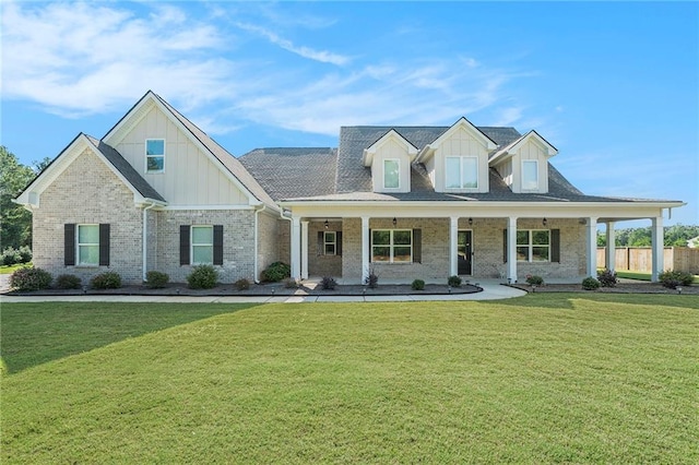 view of front of house with a front yard and a porch