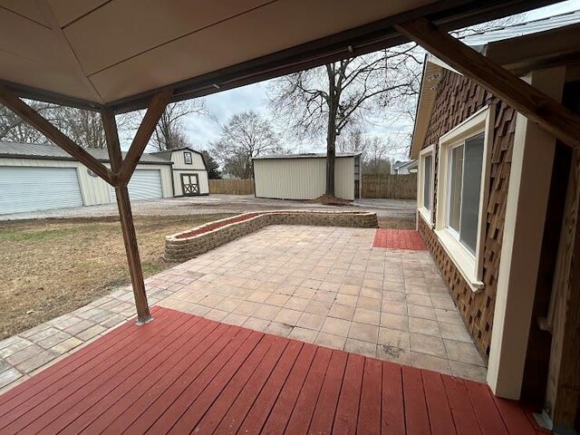 view of patio featuring a garage and an outdoor structure