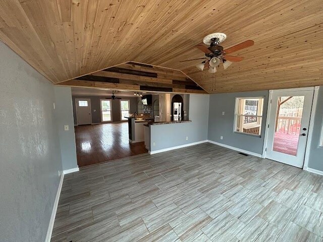 unfurnished living room with hardwood / wood-style flooring, ceiling fan, lofted ceiling, and wood ceiling