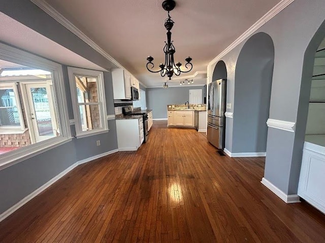 kitchen with crown molding, dark hardwood / wood-style floors, a notable chandelier, white cabinetry, and stainless steel appliances