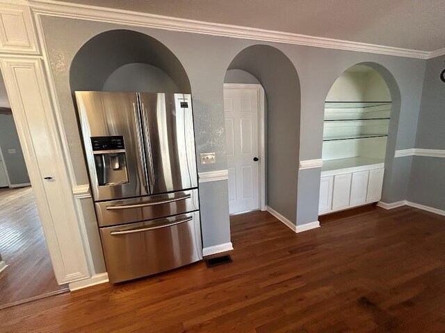 kitchen featuring stainless steel fridge with ice dispenser, dark hardwood / wood-style flooring, and crown molding