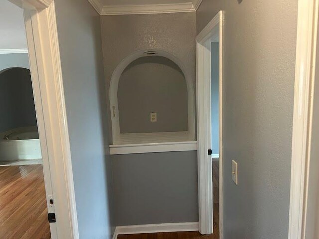 hall featuring ornamental molding and hardwood / wood-style flooring