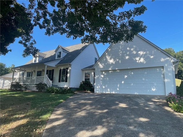 cape cod home featuring a porch, a garage, and a front lawn