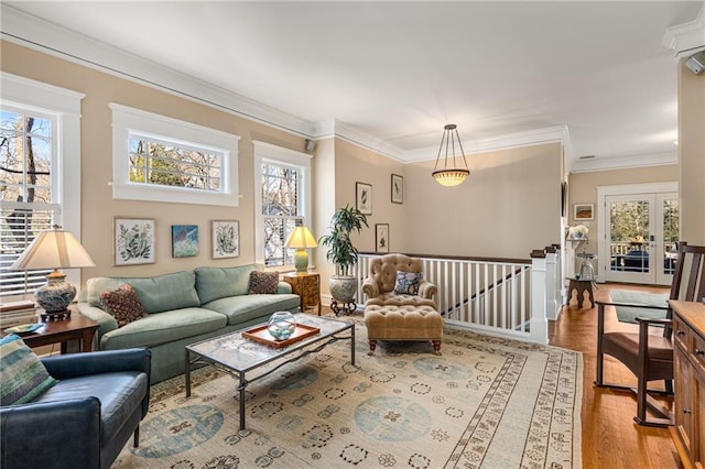 living room featuring crown molding, wood-type flooring, and french doors