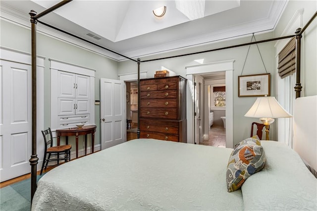 bedroom featuring crown molding and ensuite bathroom