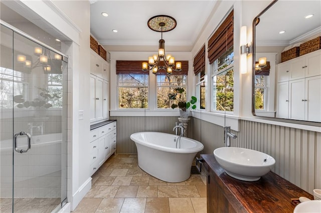 bathroom with crown molding, a healthy amount of sunlight, plus walk in shower, and a notable chandelier