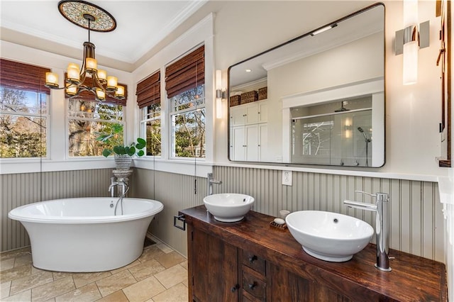 bathroom with independent shower and bath, crown molding, vanity, and a chandelier