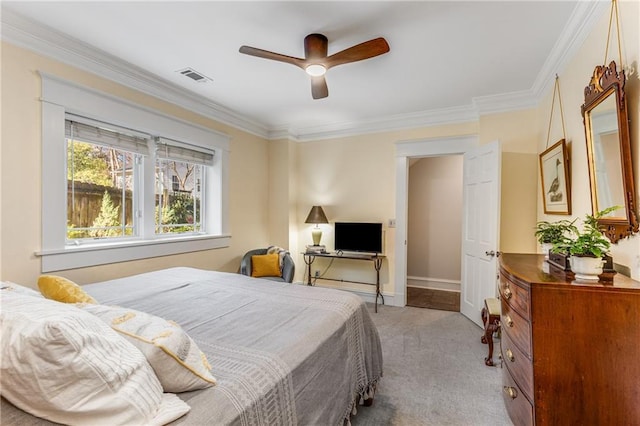 carpeted bedroom with crown molding and ceiling fan