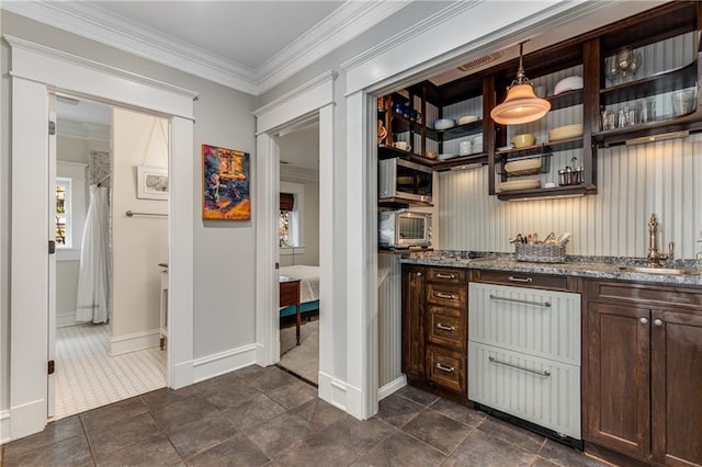 bar featuring sink, crown molding, dark brown cabinetry, stone countertops, and decorative light fixtures