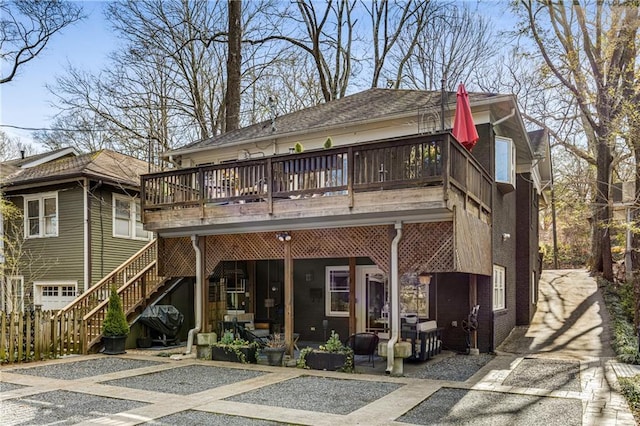 back of property featuring a wooden deck