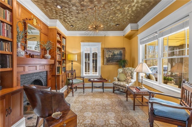 living area featuring built in shelves and ornamental molding