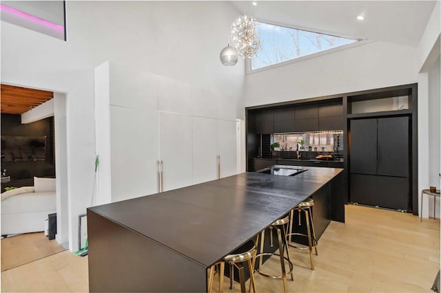 2125 Datona Dr SW, Atlanta, GA 30331 - kitchen with a towering ceiling, dark countertops, modern cabinets, white cabinetry, and a sink
